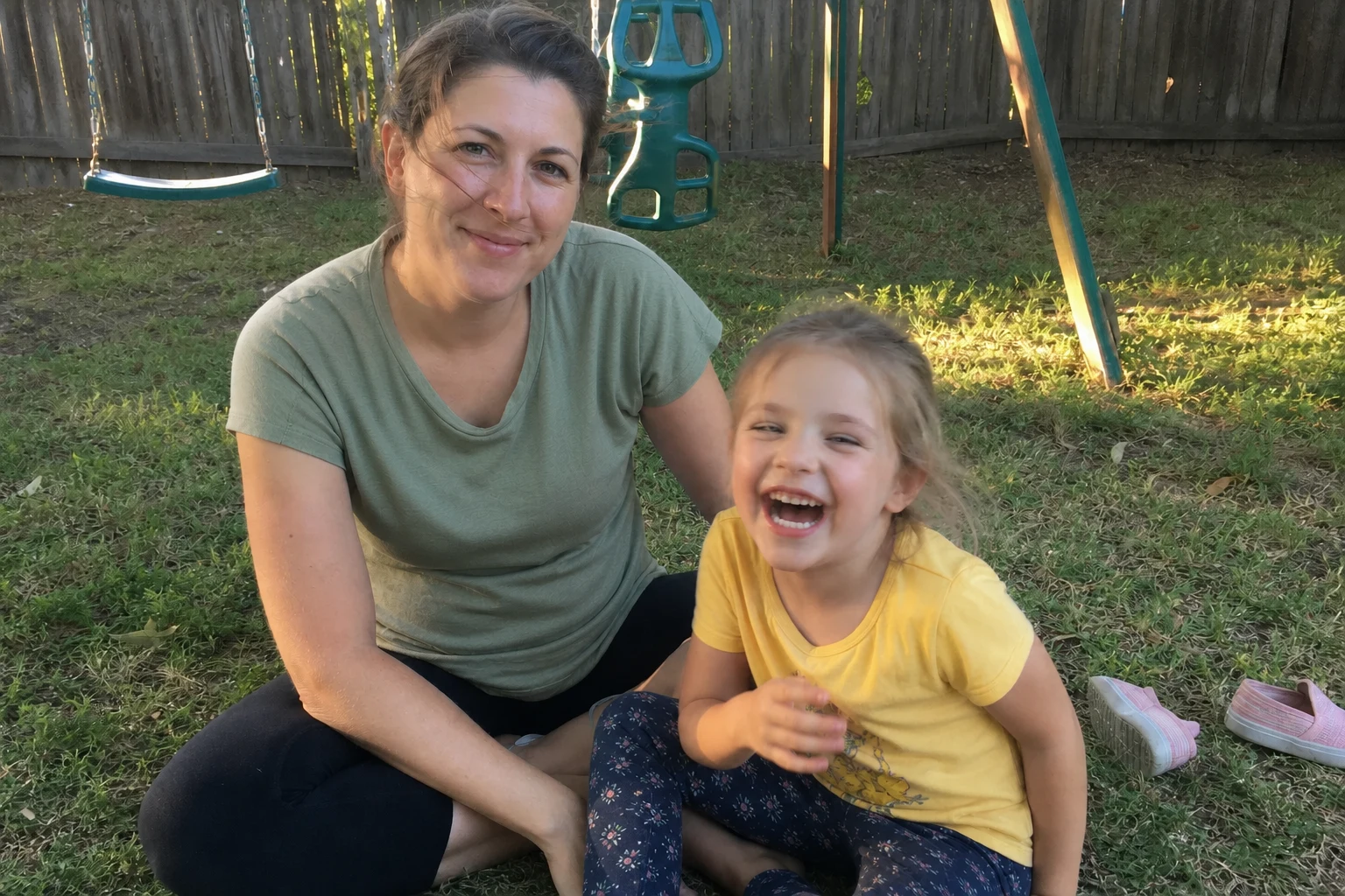 Mother and daughter sharing a playful moment in their backyard